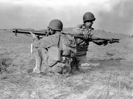October, 1943, Two soldiers of the American army loading up a bazooka gun during training exercises in England during World War Two
